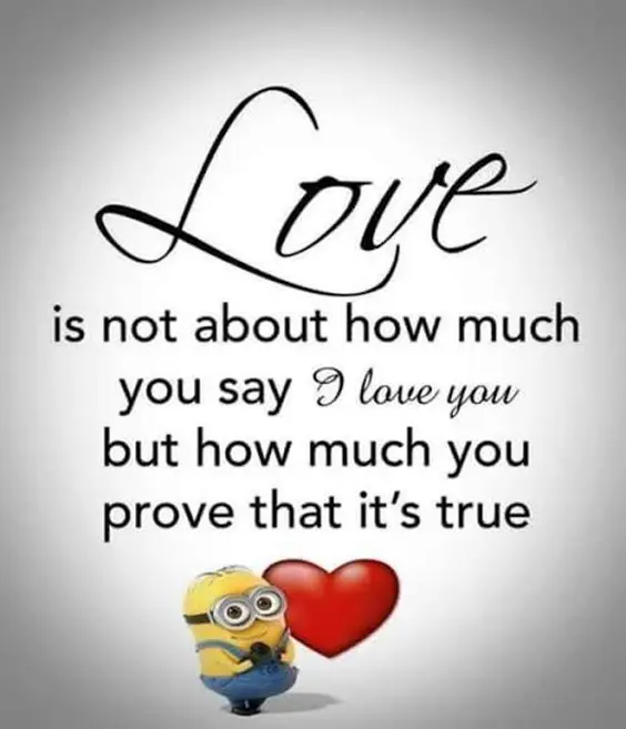 An inspirational romantic quote reading 'Love is not about how much you say I love you but how much you prove that it's true' in elegant cursive and sans-serif fonts above a Minion standing next to a big red heart. Love Is How Much You Prove It's True Minion Quote